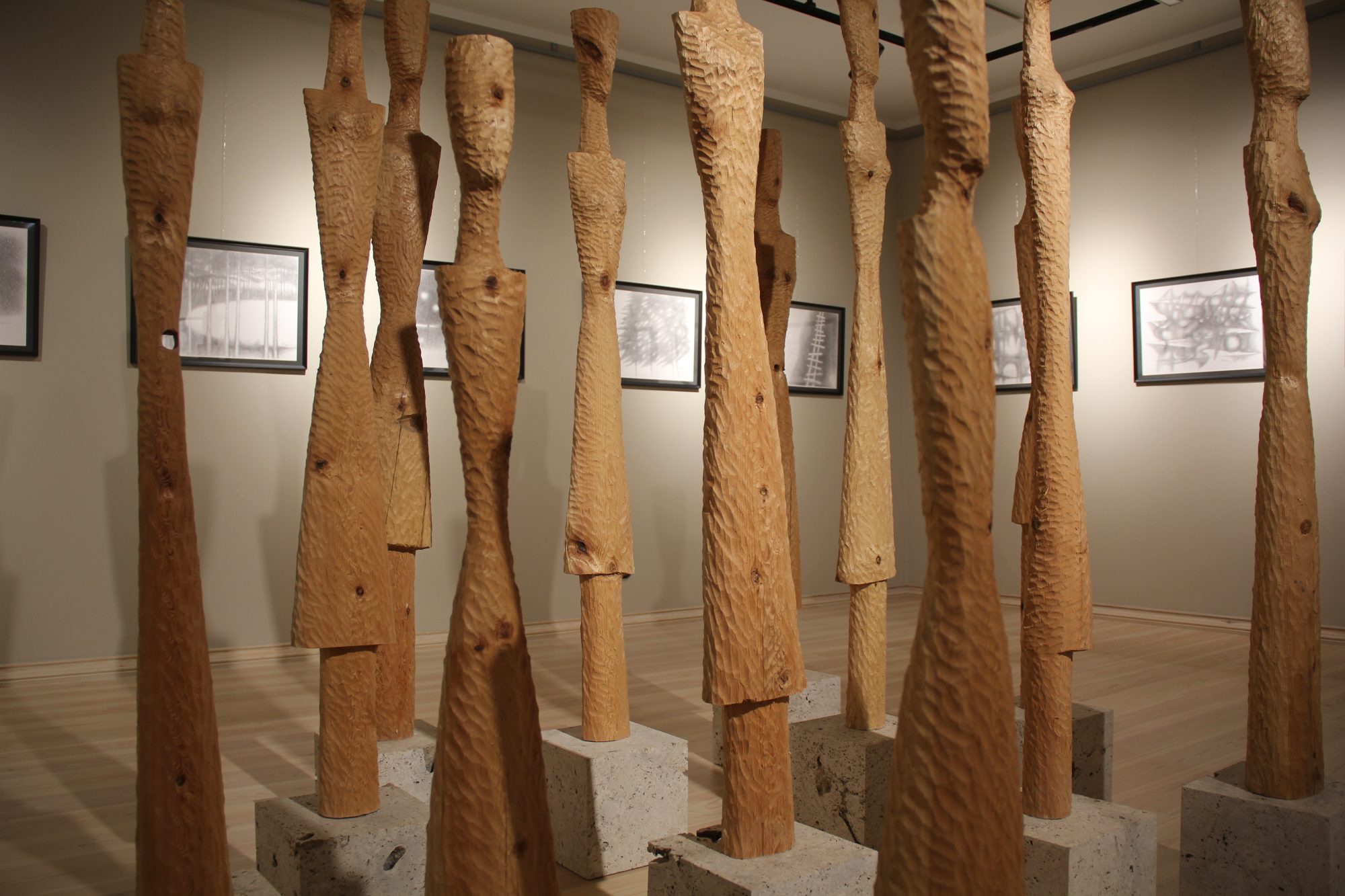 Twelve wooden sculptures and drawings